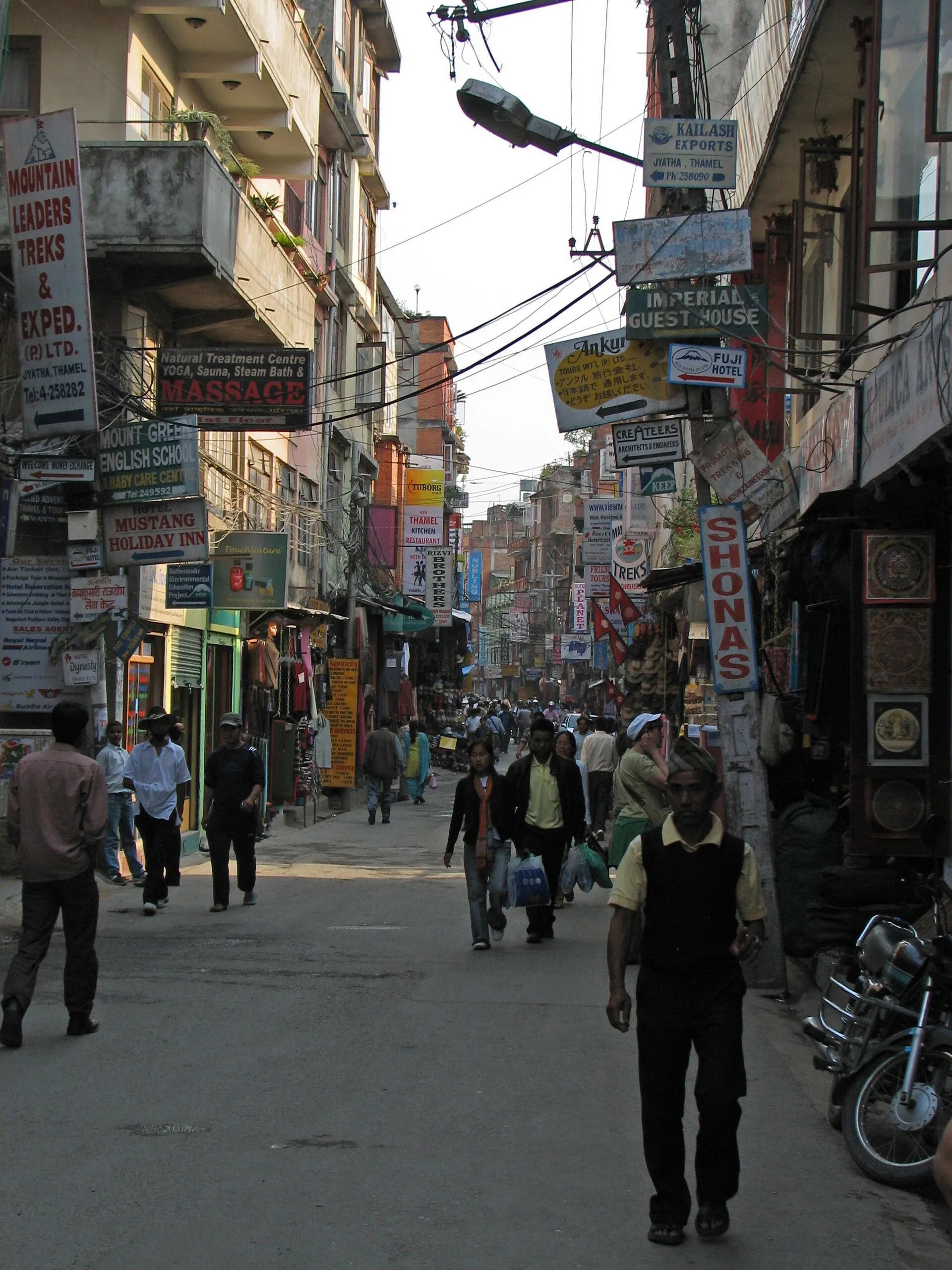 Busy street in Thamel, Kathmandu, with shop signs and people walking